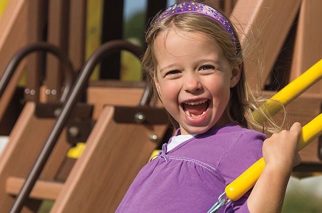 young girl on swing set